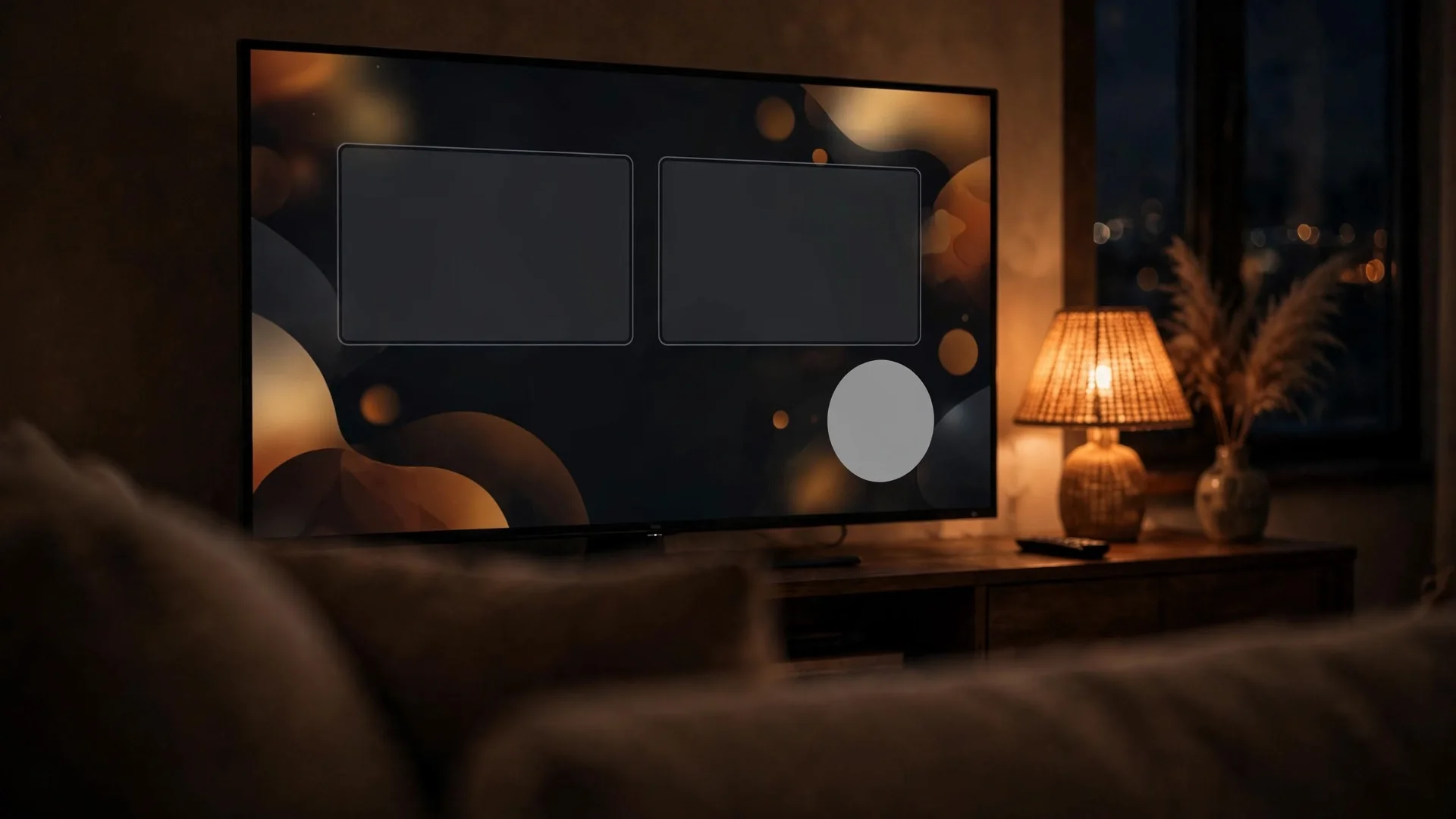 Television in a warm living room at night showing a video end screen with two empty video frames and a round subscribe circle